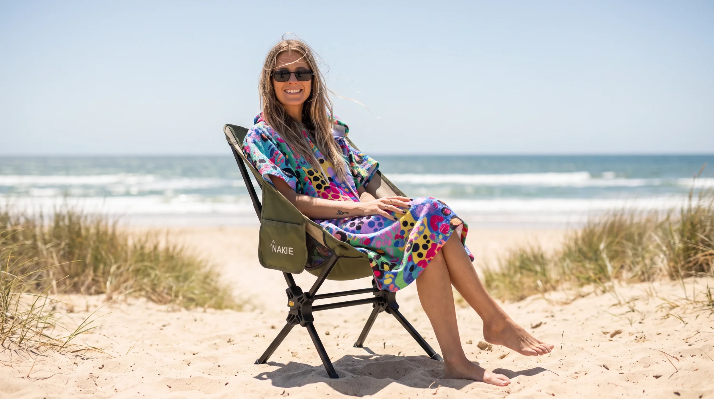 Camping Chair Nakie, olive green, set up on a beach